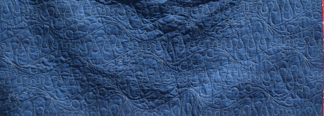 Closer view: 77000 Wisp & Waves Full Line Stencils quilted onto a quilt sample (back)
